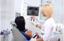 dentist using dental tools on a patient