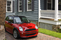 red car parked in residential driveway